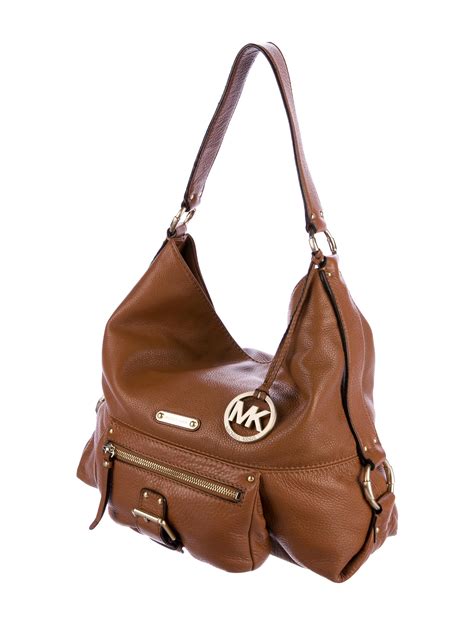 is michael kors bags real leather|is Michael Kors leather real.